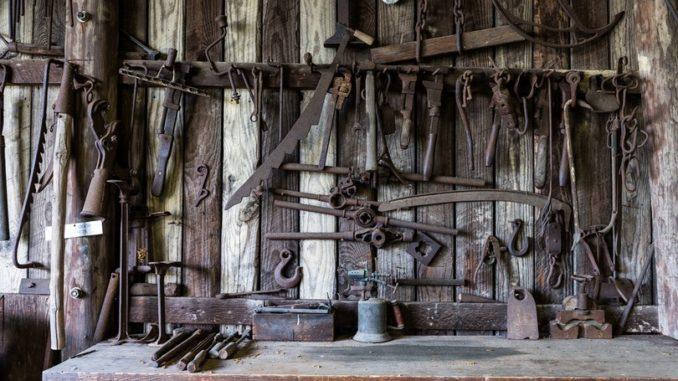 black-metal-tools-hanged-on-a-rack-near-table-162631