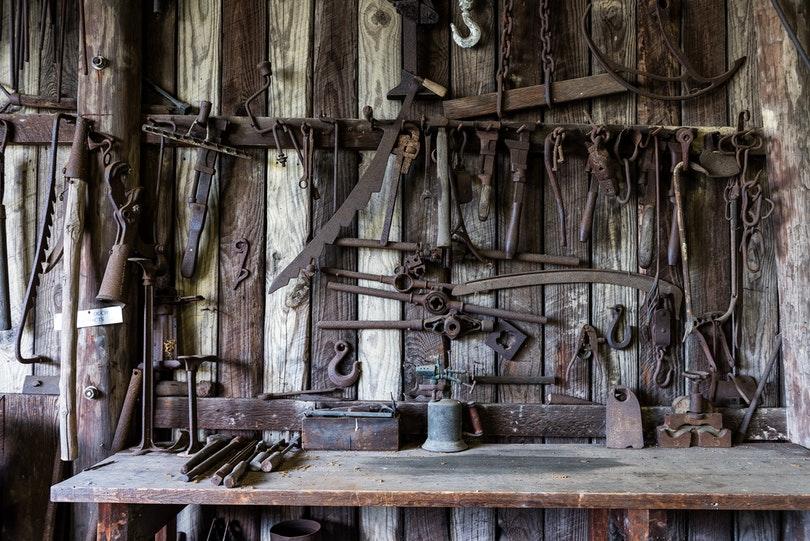 black-metal-tools-hanged-on-a-rack-near-table-162631