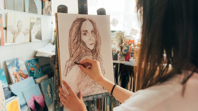 an artist drawing on a canvas